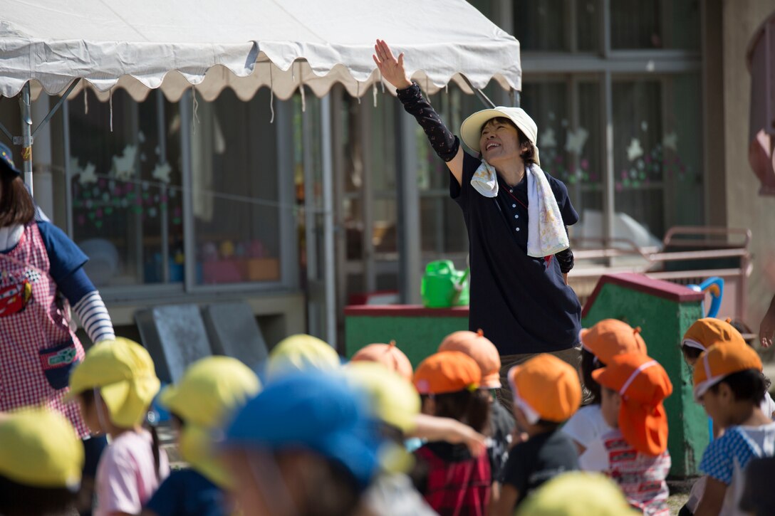 Satie Sunazaki, a teacher at Kawashimo Preschool, Iwakuni, Yamaguchi Prefeture, Japan, leads the children in a dance at Kawashimo Preschool Sept. 29, 2015. Service members from Marine Corps Air Station Iwakuni volunteered at the preschool to allow the children to learn about different cultures. This learning experience helps strenghten the bond between Americans and the Japanese.