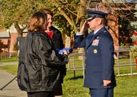 Christine Walters Chrispen, Capt. Donovan Walters’ daughter, receives a folded American flag from Col. Brian McDaniel, 92nd Air Refueling Wing commander, during a memorial rededication ceremony Oct. 15, 2015, at Medical Lake High School in Medical Lake, Wash. The ceremony was held to replace a brass faceplate that was stolen from the memorial. (U.S. Air Force photo/Airman 1st Class Taylor Bourgeous)