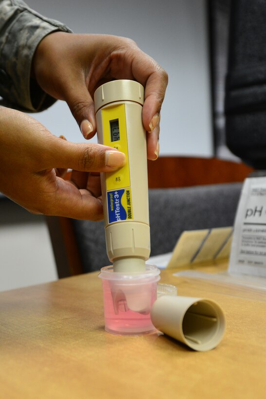 A U.S. Air Force bioenvironmental technician assigned to the 633rd Aerospace Medicine Squadron tests a water sample’s pH level at Langley Air Force Base, Va., Oct. 8, 2015. Testing the sample helps to ensure water on base is drinkable. (U.S. Air Force photo by Senior Airman Aubrey White/Released)