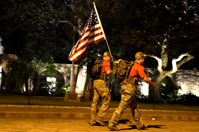 U.S. Air Force Airmen applaud Special Tactics Airmen as the ruck march on Joint Base San Antonio-Lackland, Oct. 4. The march covers more than 812 miles before ending at Hurlburt Field, Florida, in memory of fallen comrades since Sept. 11, 2001. Each Airman carries a 50-pound ruck to bring awareness to the service and sacrifice of Special Tactics members. 