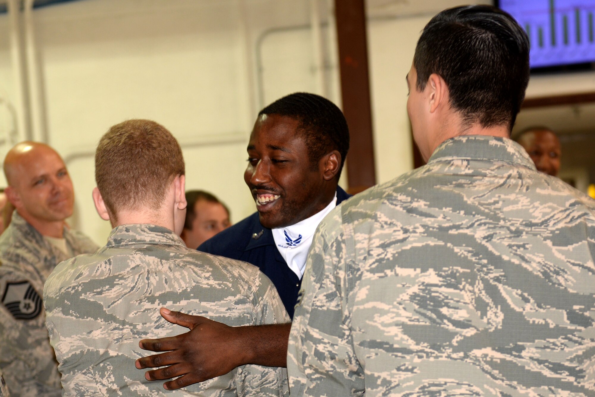 Airman 1st Class Mitchell Dixon, 4th Component Maintenance Squadron aerospace propulsion journeyman, visits with Airmen from his squadron after performing a few numbers with other Tops in Blue members, Oct. 9, 2015, at Seymour Johnson Air Force Base, North Carolina. After months of being on tour with Tops in Blue, Dixon was able to show another side of his life and career to his squadron. (U.S. Air Force photo/Airman 1st Class Ashley Williamson)