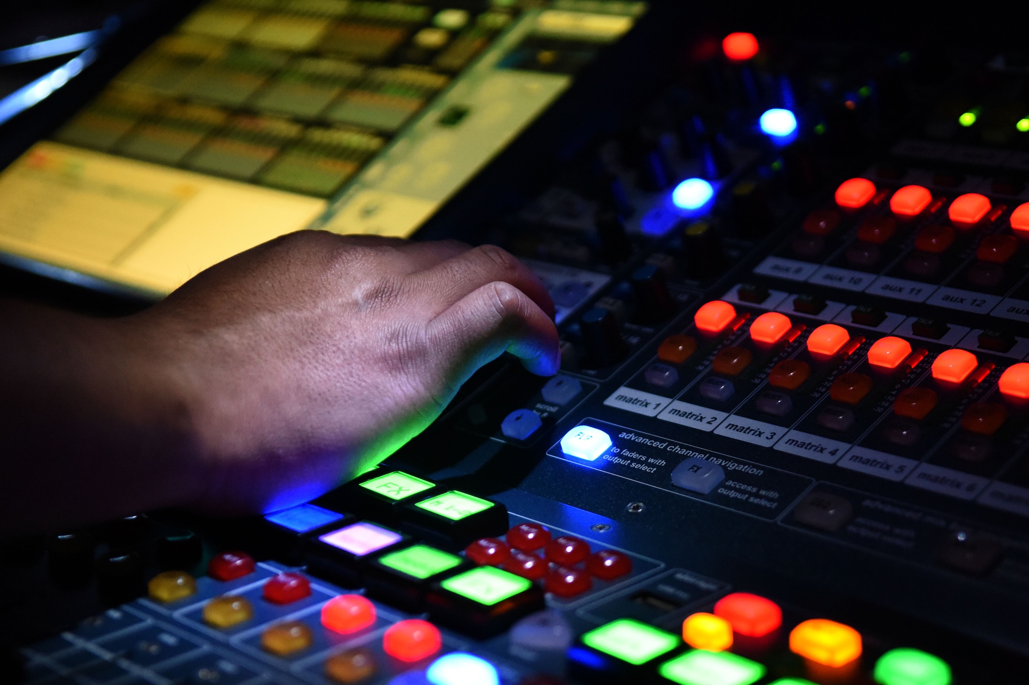 A member of the Tops in Blue technical staff makes adjustments to the lighting and sound during the performance, Oct. 10, 2015, at Seymour Johnson Air Force Base, North Carolina. Tops in Blue has seven technical staff members to take care of lighting, transportation, video and audio. (U.S. Air Force photo/Senior Airman Aaron J. Jenne)