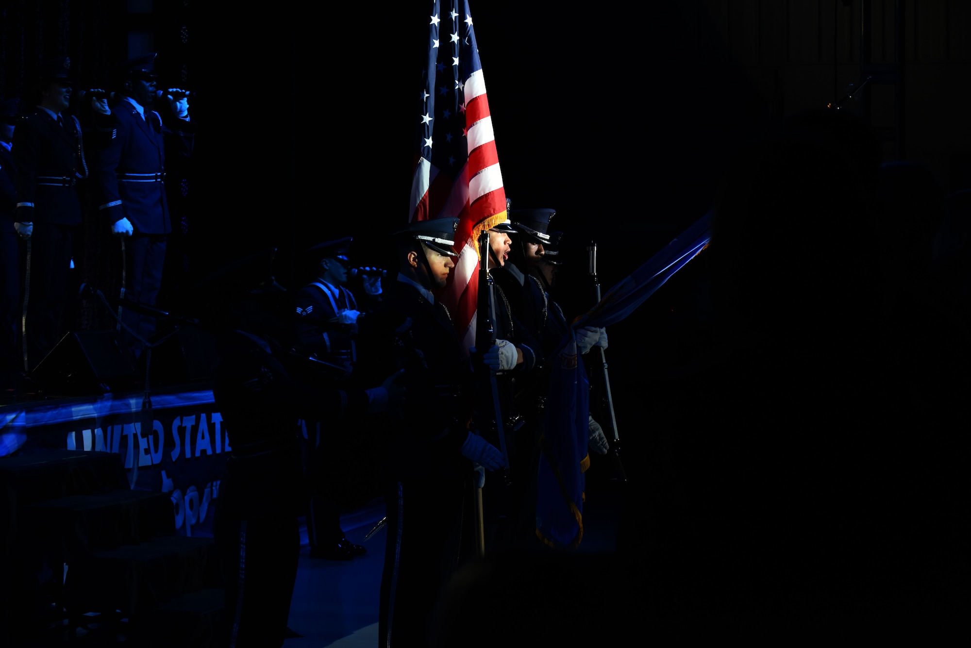 Tops in Blue members present the colors and sing the National Anthem to kick off the show, Oct. 10, 2015, at Seymour Johnson Air Force Base, North Carolina. Tops in Blue serves as an expeditionary entertainment unit to provide quality entertainment from within Air Force resources for Air Force personnel stationed worldwide. (U.S. Air Force photo/Senior Airman Aaron J. Jenne)