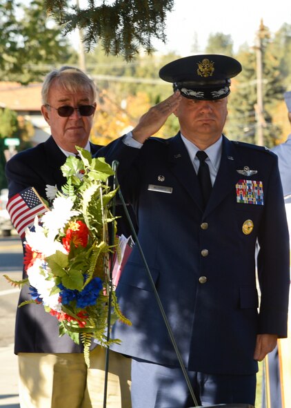 Col. Brian McDaniel, 92nd Air Refueling Wing commander, salutes while taps is played during a rededication memorial ceremony for Capt. Donovan Walters Oct. 15, 2015 at Medical Lake High School in Medical Lake, Wash. The Jonas Babcock Chapter, National Society Daughters of the American Revolution, sponsored the event which replaced the stolen faceplate with a recessed granite plate, in hopes that this will be the final re-dedication of the memorial. (U.S. Air Force photo/Airman 1st Class Taylor Bourgeous)