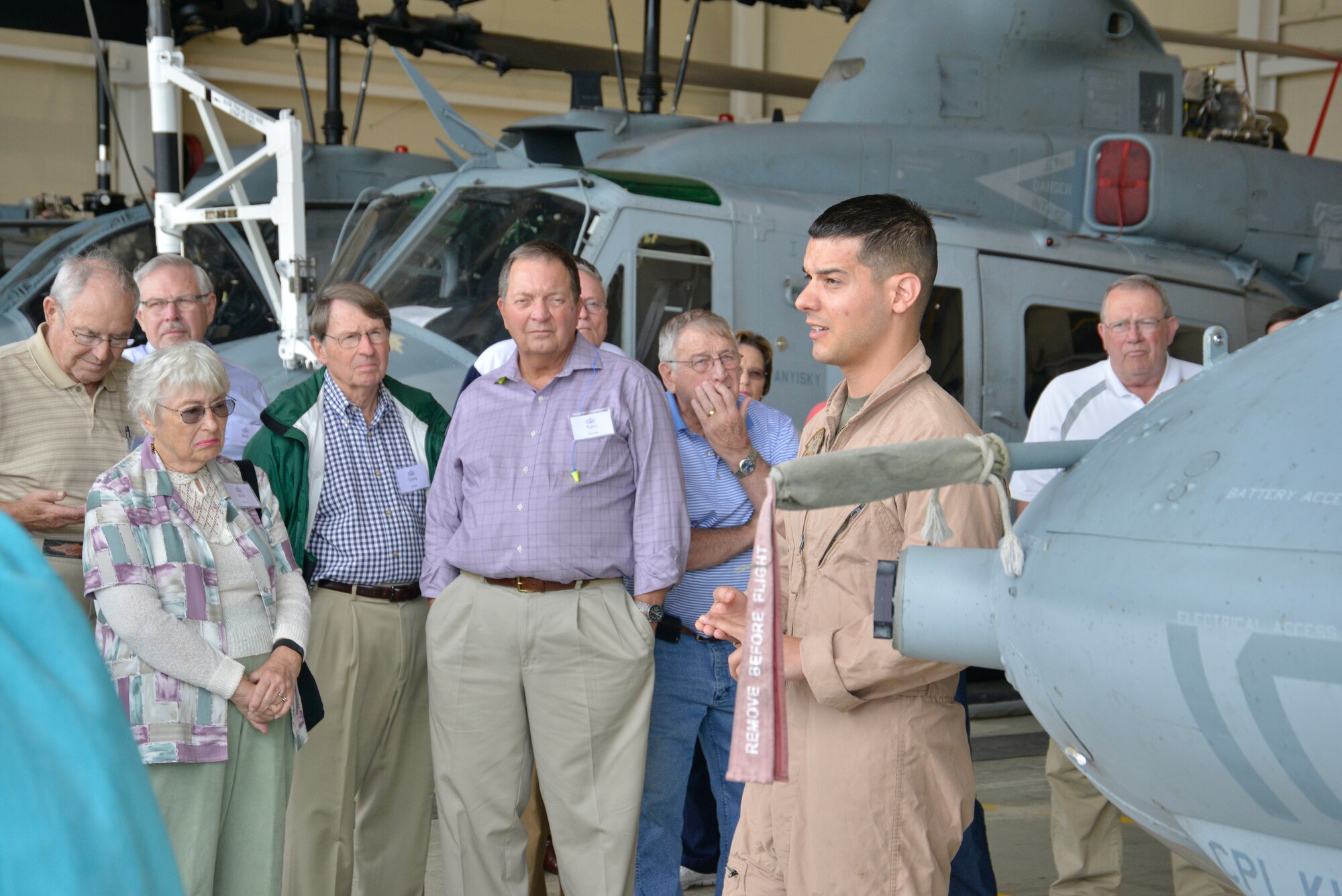 Marine Capt. Jason Delisle, UH-1Y Super Huey pilot, briefs Senior Retired Air Force Transportation Officer Reunion participants during a tour of Marine Aircraft Group 49, Det. A. U.S. Air Force photo by Ed Aspera