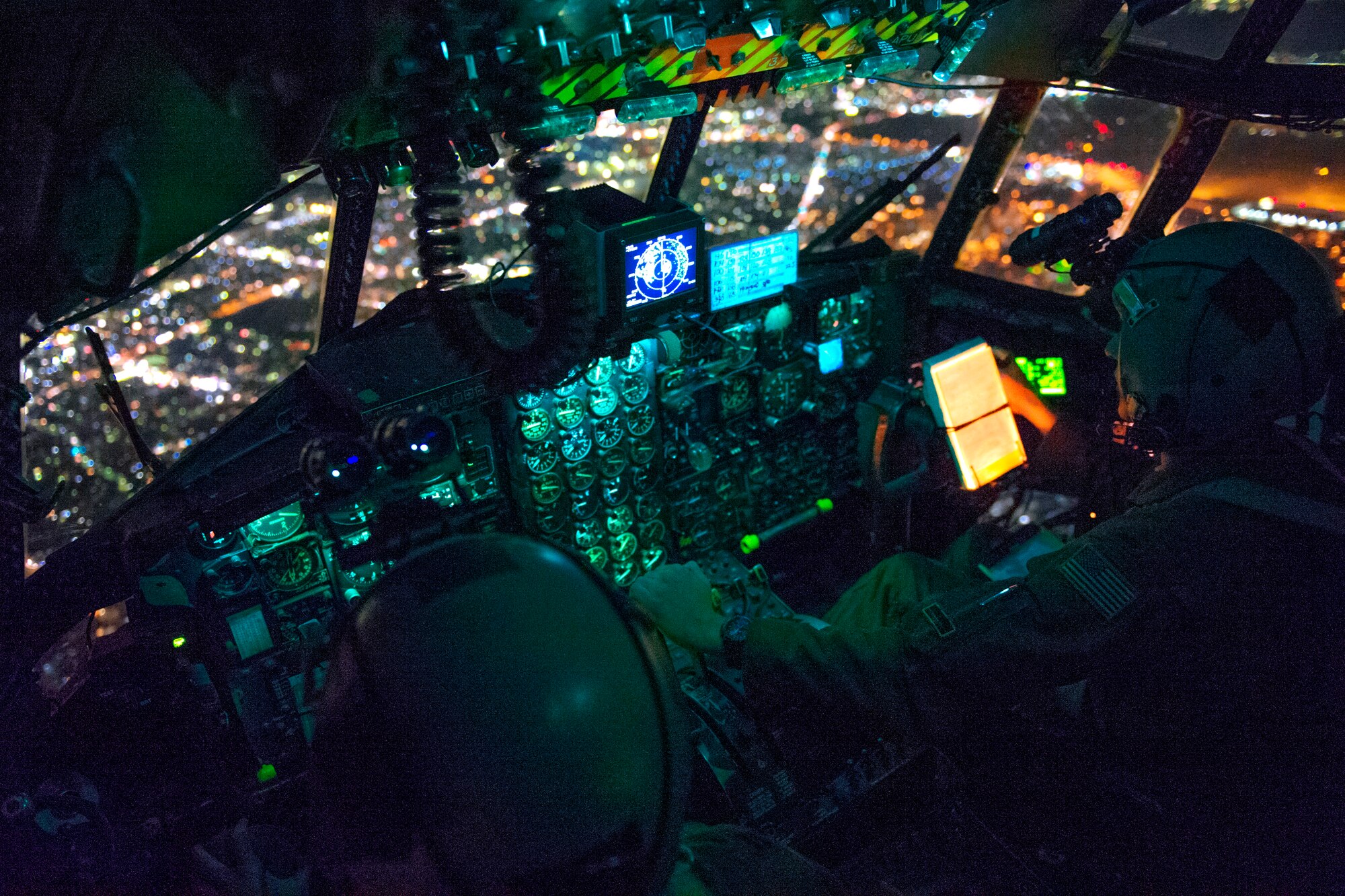 Capt. Stephen Elliot and 1st Lt. Stephen Pineo, 36th Airlift Squadron pilots, prepare to perform an assault landing during a night operations exercise over Yokota Air Base, Japan, Oct. 14, 2015. The training enhanced the pilots’ ability to operate in the dark. (U.S. Air Force photo by Airman 1st Class Delano Scott/Released)