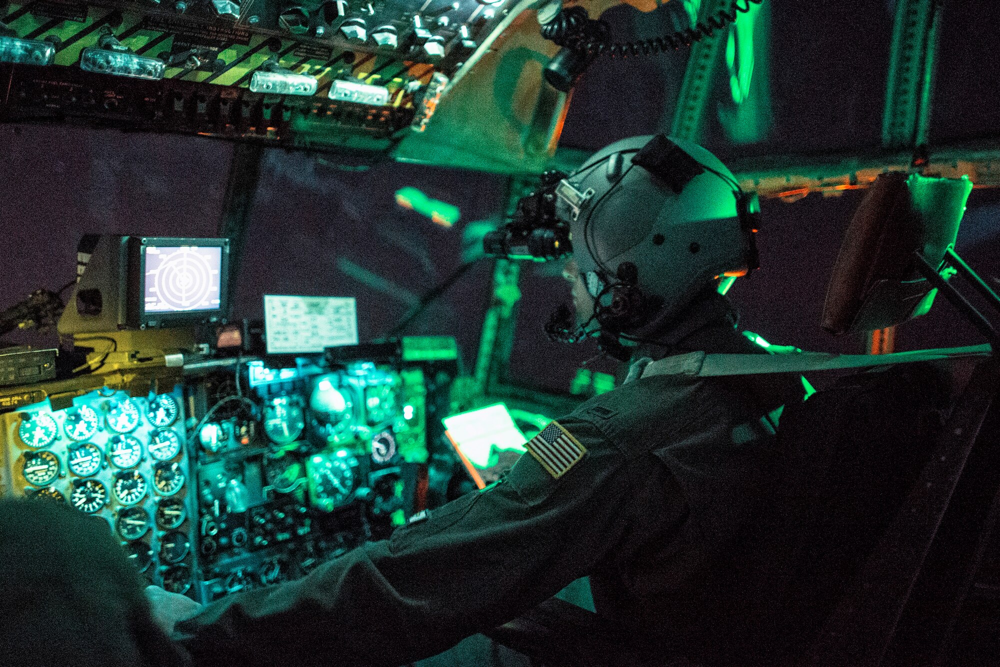 1st Lt. Randall Kanzelmeyer, 36th Airlift Squadron c-130 Hercules pilot, wears a night vision goggle during a training mission above Yokota Air Base, Japan, Oct. 14, 2015. Yokota aircrews regularly conduct night flying operations to ensure they’re prepared to respond to a variety of contingencies throughout the Indo-Asia Pacific region. (U.S. Air Force photo by Osakabe Yasuo/Released)