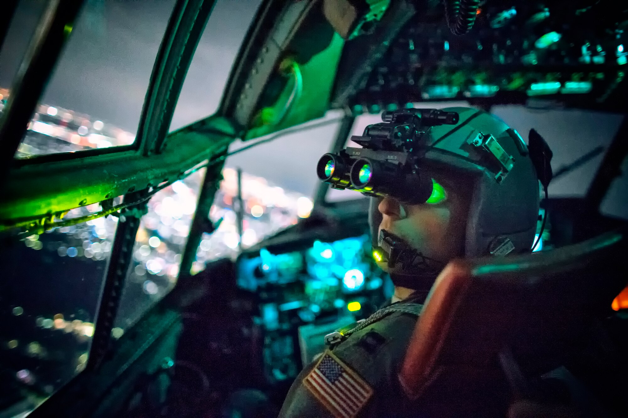 Capt. Thomas Bernard, 36th Airlift Squadron C-130 Hercules pilot, performs a visual confirmation with a night vision goggle during a training mission over Kanto Plane, Japan, Oct. 14, 2015. Yokota aircrews regularly conduct night flying operations to ensure they’re prepared to respond to a variety of contingencies throughout the Indo-Asia Pacific region. (U.S. Air Force photo by Osakabe Yasuo/Released)
