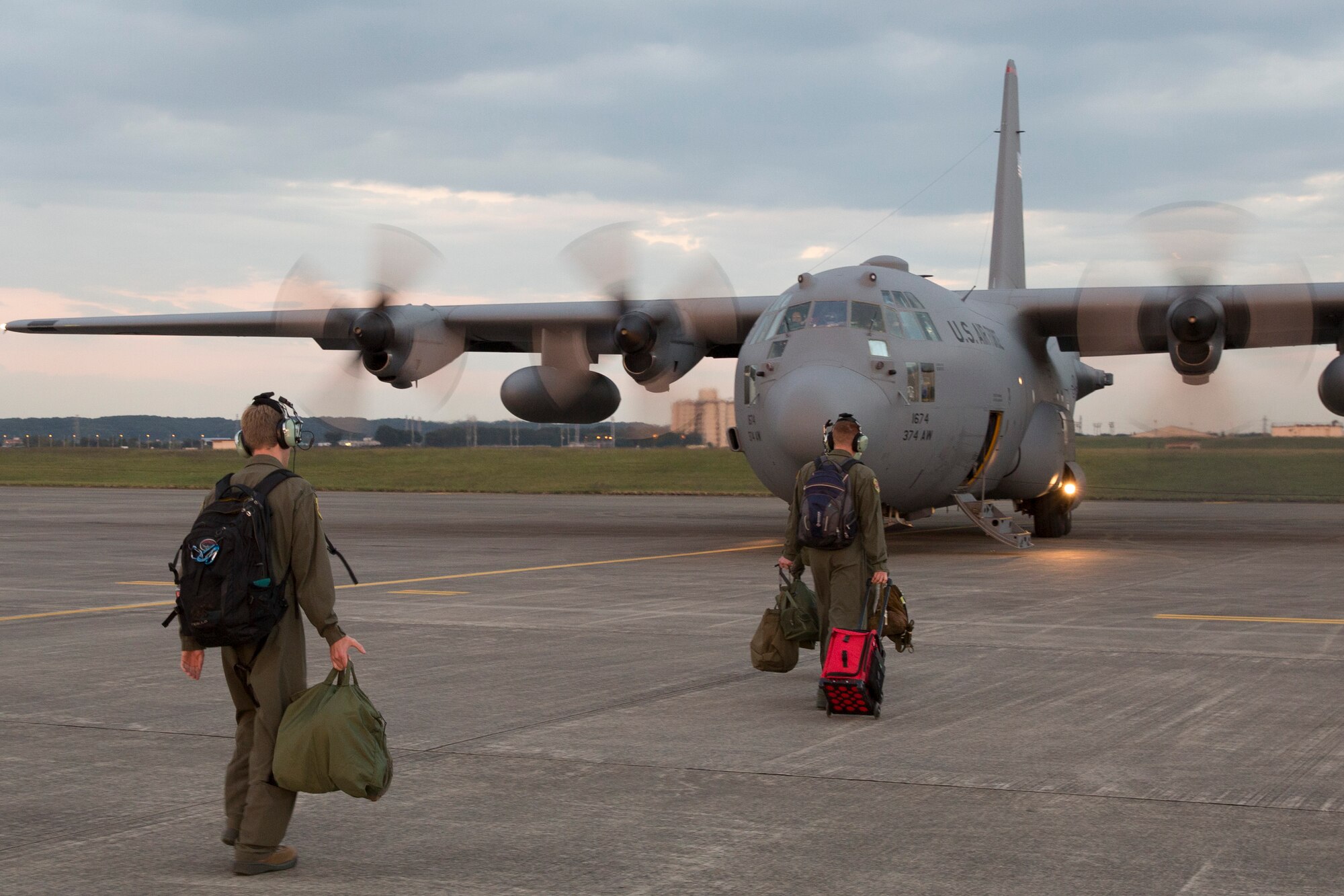 Aircrews walk to a C-130 Hercules at Yokota Air Base, Japan, Oct. 14, 2015, during a training mission. The training mission ensured that the airlifters are ready to respond to a variety of contingencies throughout the Indo-Asia Pacific region.  (U.S. Air Force photo by Osakabe Yasuo/Released) 