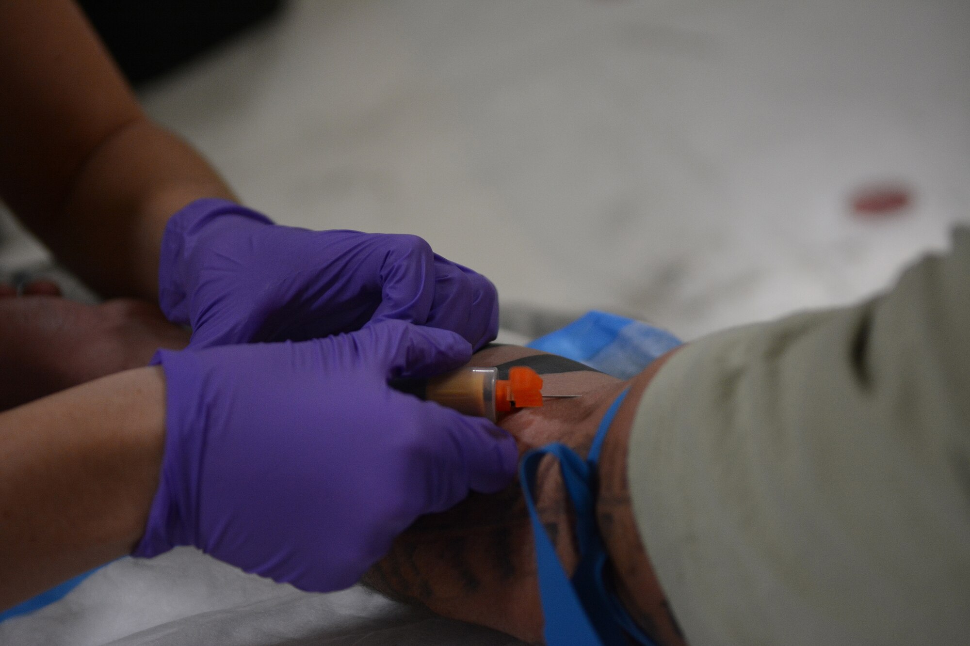 An Airman from the 115th Medical Group draws blood during the physical health assessments in building 510 at the 115th Fighter Wing, Madison, Wis., Oct. 3, 2015. More than 890 Airmen from the Wing were processed during the Quick PHA, designed to include less wait time, more time for members to spend in their respective squadrons throughout the year, and a more personalized one-on-one health care visit for each member. (U.S. Air National Guard photo by Senior Airman Andrea F. Rhode)