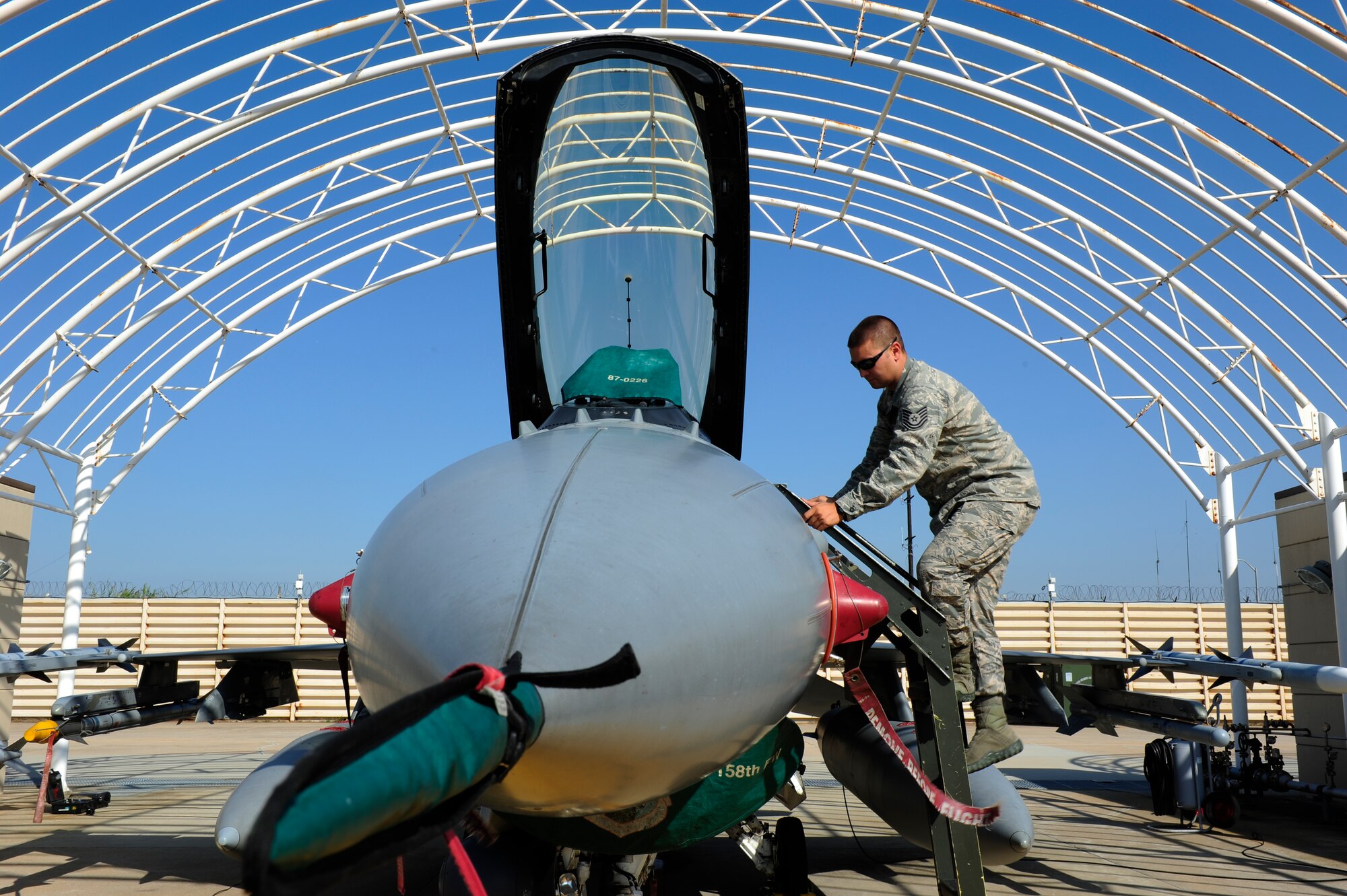 Tech. Sgt. Brett Larson, 134th Expeditionary Fighter Squadron F-16 Fighting Falcon crew chief, Vermont Air National Guard, climbs a ladder to inspect the cockpit of an F-16 at Kunsan Air Base, Republic of Korea, Oct. 6, 2015. The 134th EFS was redeployed from Kadena Air Base, Japan to Kunsan AB as part of a theater security package. Movement of TSPs into the Pacific region is a routine and integral part of U.S. Pacific Command’s force posture. (U.S. Air Force photo by Staff Sgt. Nick Wilson/Released)