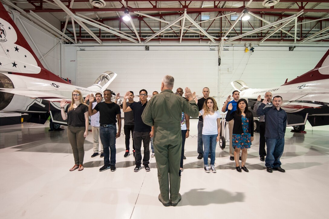 Col. Ross R. Anderson (foreground, center), 926th Wing commander, administers the oath of enlistment to future Airmen of the 926th WG at Thunderbird Hangar on Nellis Air Force Base, Nev., Oct. 9, 2015. The 926th WG is headquartered at Nellis AFB and consists of two groups, 12 squadrons and one detachment located across the nation. Through Total Force Integration, reservists are integrated into regular Air Force units, accomplishing the U.S. Air Force Warfare Center and 432nd Wing/432nd Air Expeditionary Wing missions side-by-side regular Air Force personnel on a daily basis. During the swearing-in ceremony, Anderson said “I'm envious of the adventures, challenges, successes and life-events that they are going to experience in their time in the Air Force. They have joined an elite culture, and they get to look forward to working with the best people in the greatest military to have ever existed.” (U.S. Air Force photo by Staff Sgt. Siuta B. Ika)