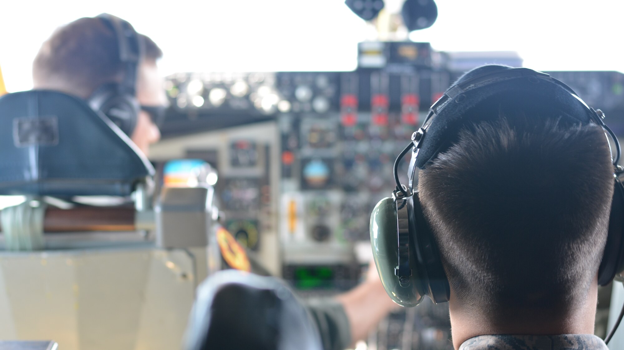 Senior Airman Donavan Furr, an aircraft hydraulics technician with the 507th Aircraft Maintenance Squadron, observes as the pilot and co-pilot complete the pre-landing checklist Oct. 3, 2015, at Tinker Air Force Base, Oklahoma. Furr was one of more than a dozen Airmen chosen to participate in an incentive flight for first-term airmen within the 507th Air Refueling Wing. (U.S. Air Force photo/Senior Airman Jeffery Dahlem)