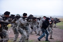 Members of the 28th Security Forces Squadron move at the low-ready position during a shoot, move, communicate training event at Ellsworth Air Force Base, S.D., Sept. 29, 2015. Airmen and civilian security forces members practiced engaging their targets, communicating and protecting one another on a simulated battlefield. (U.S. Air Force photo/Airman 1st Class James L. Miller)