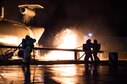 Firefighters and base leadership demonstrate extinguishing an aircraft fire Oct. 8, 2015, at Ramstein Air Base, Germany. As part of Fire Prevention Week, families visited Fire Station 1 to learn about fire safety, including home-fire safety issues, fire extinguisher training and holiday safety tips. (U.S. Air Force photo/Senior Airman Damon Kasberg)