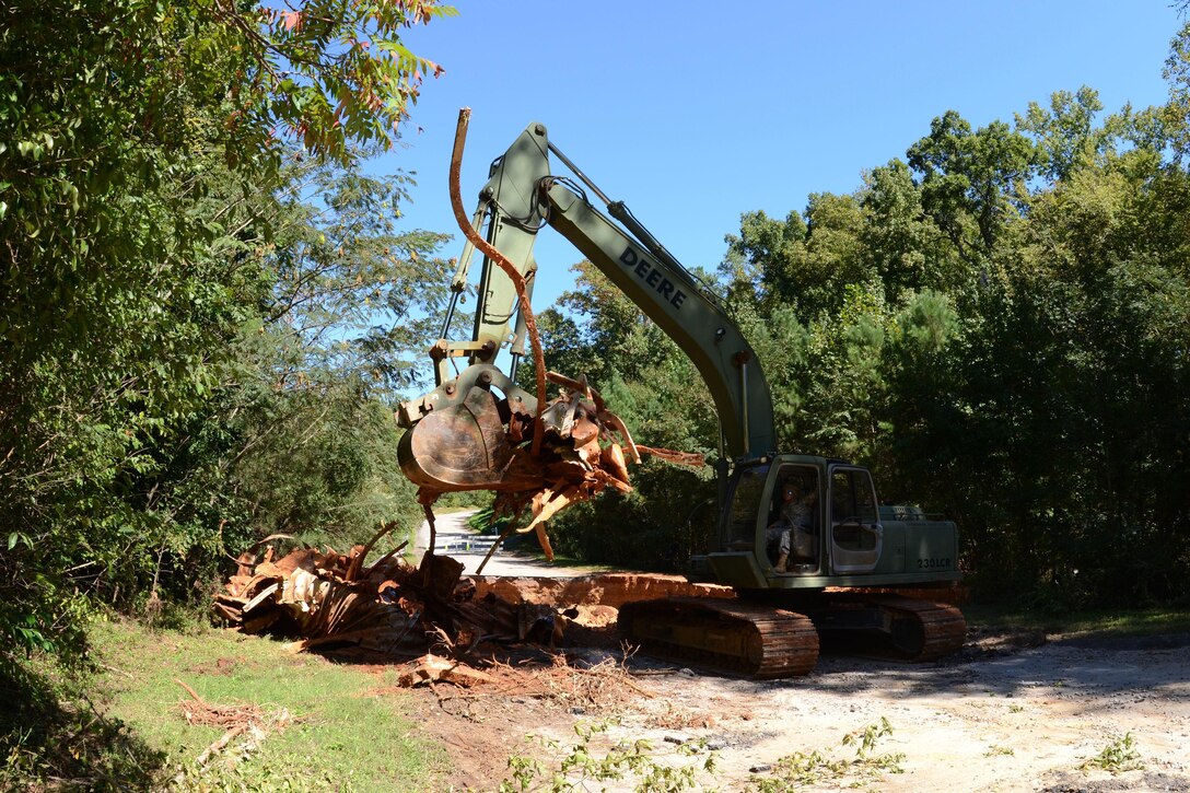 A South Carolina Army National Guard soldier removes debris with heavy equipment on Botanical Parkway, West Columbia, S.C., during a statewide flood response Oct. 14, 2015. South Carolina Air National Guard photo by Airman Megan Floyd