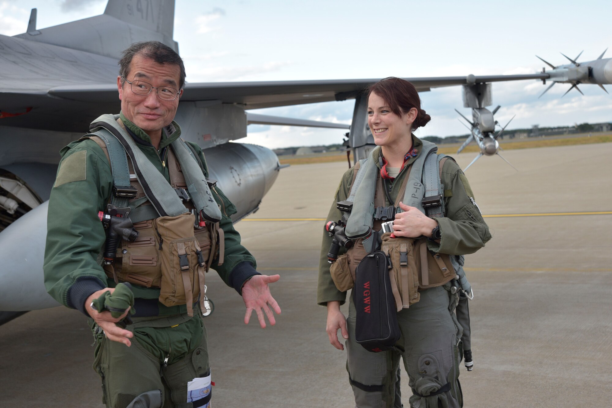 Japan Air Self-Defense Force Lt. Gen. Yoshiyuki Sugiyama, the Air Defense Command commander, praises Maj. Jessa Charron, a 13th Fighter Squadron pilot, on being an excellent and professional fighter pilot at Misawa Air Base, Japan, Oct. 14, 2015. Sugiyama mentioned that this flight has encouraged him in accelerating the study for introducing female fighter pilots in the JASDF. (U.S. Air Force photo/Senior Airman Jose L. Hernandez-Domitilo)