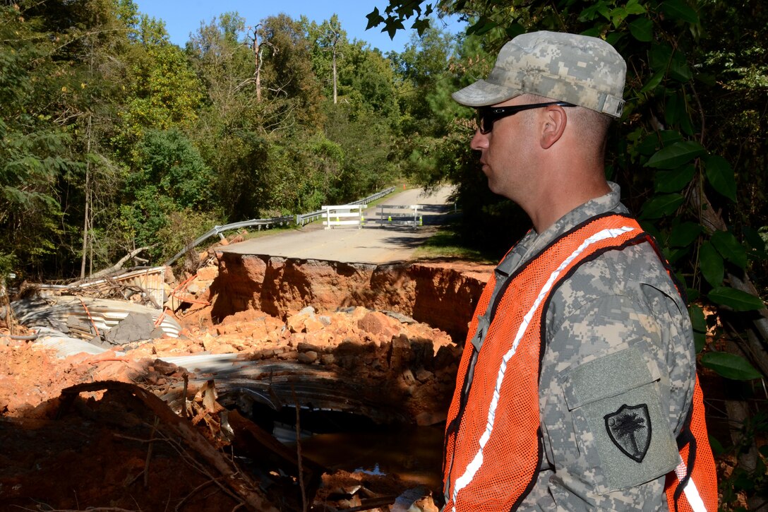 South Carolina Army National Guard Sgt. Brentt Moyner watches debris removal on Botanical Parkway, West Columbia, S.C., during a statewide flood response Oct. 14, 2015. Moyner is a horizontal construction engineer assigned to the South Carolina National Guard's 124th Engineer Company, 122nd Engineer Battalion. South Carolina Air National Guard photo by Airman Megan Floyd