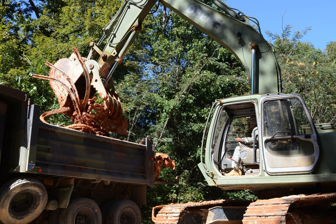 South Carolina Army National Guard Sgt. Darias Echols operates a hydraulic excavator to move debris from Botanical Parkway, West Columbia, S.C., during a statewide flood response Oct. 14, 2015. Echols is a horizontal construction engineer assigned to the South Carolina National Guard's 124th Engineer Company, 122nd Engineer Battalion. South Carolina Air National Guard photo by Airman Megan Floyd