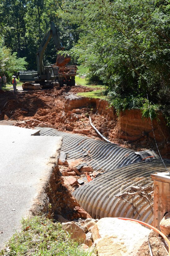 South Carolina Army National Guard soldiers operate heavy equipment to remove debris and repair a road on Botanical Parkway, West Columbia, S.C., during a statewide flood response Oct. 14, 2015. South Carolina Air National Guard photo by Airman Megan Floyd