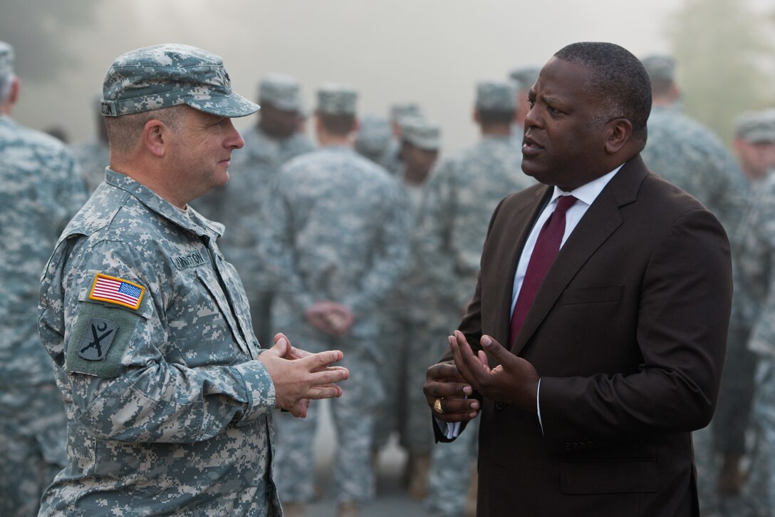 Army National Guard Maj. Gen. Robert E. Livingston Jr. speaks with Columbia, S.C., Mayor Stephen K. Benjamin at a riverfront canal Oct. 14, 2015. The South Carolina National Guard has activated 2,200 members to support state and county emergency management agencies, and local first responders, as historic flooding impacted counties statewide. Livingston is the state adjutant general. South Carolina Air National Guard photo by Tech. Sgt. Jorge Intriago