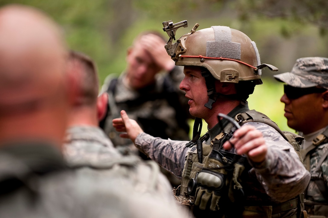 Master Sgt. Brandon Herber, a member of the 122nd Security Forces Squadron from the 122nd Fighter Wing, Fort Wayne, Ind., explains proper tactics to a squad of Airmen during an ambush exercise, July 29, 2015, at the Combat Readiness Training Center, Alpena, Mich. Airmen from the 122nd Fighter Wing were training at the CRTC as part of their annual training. (Air National Guard photo by Staff Sgt. William Hopper)