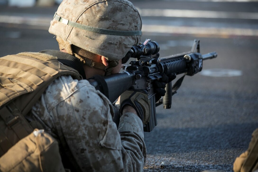 ARABIAN GULF (Oct. 14, 2015) A U.S. Marine with India Battery, Battalion Landing Team 3rd Battalion, 1st Marine Regiment, fires at his target during a deck shoot aboard the amphibious assault ship USS Essex (LHD 2). The Marines zeroed their weapons to ensure they were s accurately. The 15th MEU, embarked on the ships of the Essex Amphibious Ready Group, is deployed to maintain regional security in the U.S. 5th Fleet area of operations. (U.S. Marine Corps video by Cpl. Anna Albrecht/ Released)