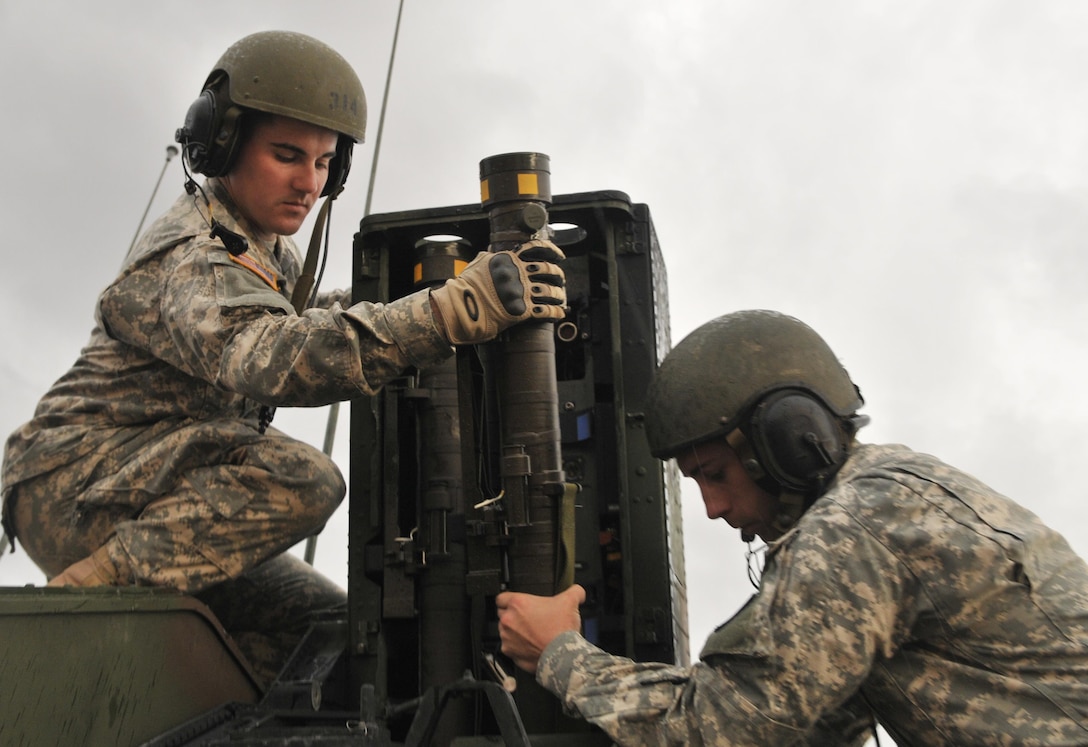 Mississippi Army National Guard Pfc. Thomas A. Hoey and Sgt. Brandon L. Kilts load a stinger ground-to-air missile into an Avenger vehicle pod during a live-fire exercise on Fort Bliss, Texas, Oct. 7, 2015. Hoey is an avenger gunner and Kilts is a team chief assigned to 1st Battalion, 204th Air Defense Artillery Regiment. Mississippi Army National Guard photo by Staff Sgt. Shane Hamann