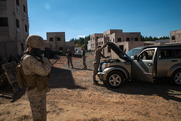 Marines from Alpha Company, Marine Barracks Washington, D.C. search a vehicle at a vehicle control point as part of a military operations in urban terrain exercise at Marine Corps Base Quantico, Va. Oct. 15, 2015.  (U.S. Marine Corps photo by Cpl. Christian Varney/Released)