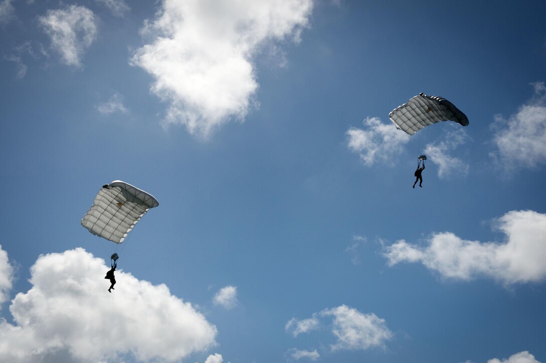 Explosive Ordnance Disposal technicians assigned to Explosive Ordnance Disposal Mobile Unit 5 approach a landing zone during military free fall jump sustainment training in Santa Rita, Guam, Oct. 14, 2015. U.S. Navy photo by Petty Officer 1st Class Ace Rheaume