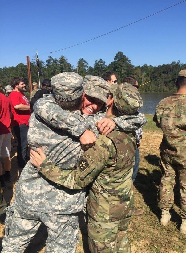 Maj. Lisa Jaster, 37, an Army Reserve engineer officer, hugs fellow West Point graduates and Active Duty officers Capt. Kristen Griest, 26, and 1st Lt. Shaye Haver, 25. the three women are the first female Soldiers to earn the distinctive black-and-gold Ranger tab from the combat leadership course.