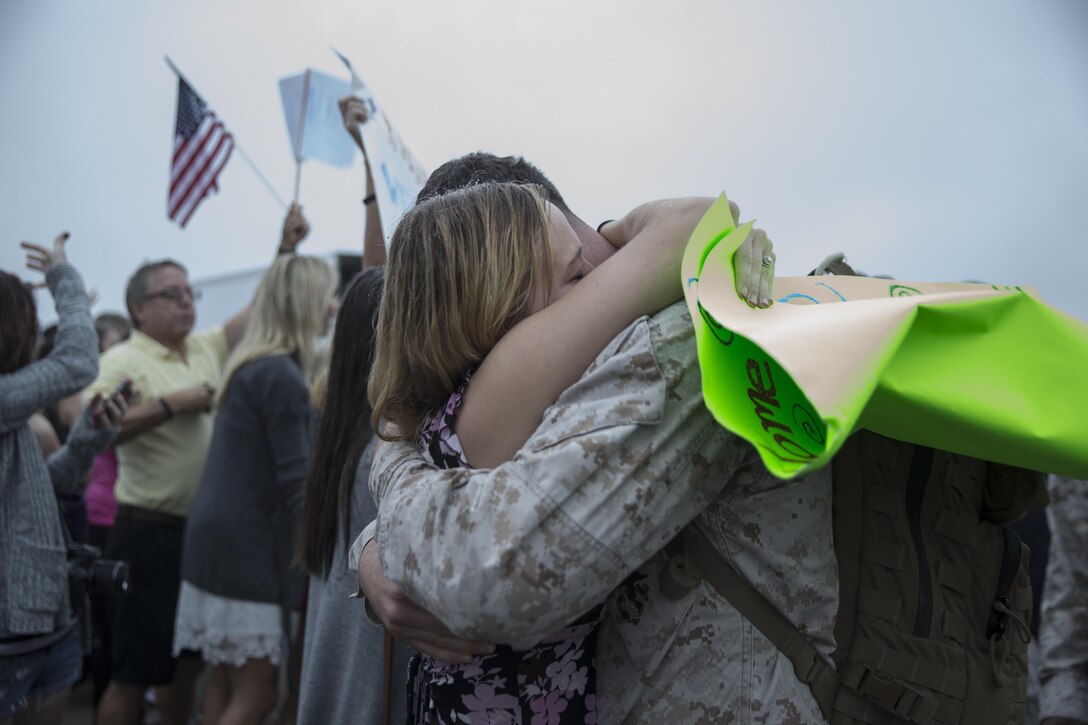 A Marine with Marine Fighter Attack Squadron (VMFA) 232 greets a loved one upon returning from a six-month deployment aboard Marine Corps Air Station Miramar, Calif., Oct. 16. Fellow service members, friends and family members greeted the Marines and Sailors on the flight line of MCAS Miramar. (U.S. Marine Corps photo by Sgt. Lillian Stephens/Released)