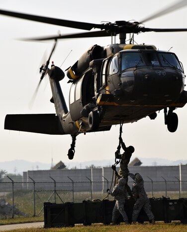 OSAN AIR BASE, South Korea Soldiers assigned to 6-52 ADA, attach a Missile Round Trainer to a UH-60L Black Hawk helicopter during sling load training at Osan Air Base, Oct. 14. Soldiers trained with flight crews from Alpha Company, 2-2 ASLT based at K-16 Air Base, Korea. 