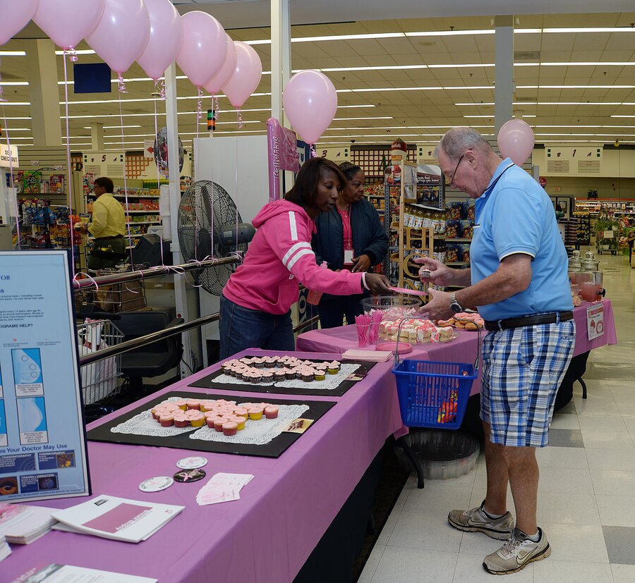 As patrons enter Marine Corps Logistics Base Albany’s Commissary, Oct. 16, the first thing they saw was a small section decorated in pink.  Important information, buttons, different kinds of sweets and pink lemonade sat on a long table. Commissary employees greeted patrons, welcoming them to the Breast Cancer Awareness “Pink Out” Extravaganza. The event was held by the employees to promote awareness and support several fellow employees battling cancer.