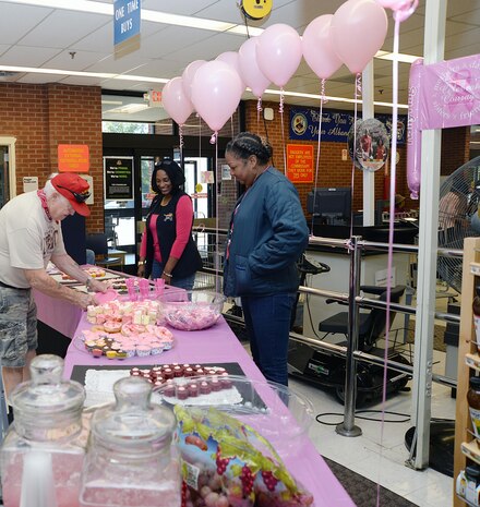 As patrons enter Marine Corps Logistics Base Albany’s Commissary, Oct. 16, the first thing they saw was a small section decorated in pink.  Important information, buttons, different kinds of sweets and pink lemonade sat on a long table. Commissary employees greeted patrons, welcoming them to the Breast Cancer Awareness “Pink Out” Extravaganza. The event was held by the employees to promote awareness and support several fellow employees battling cancer.