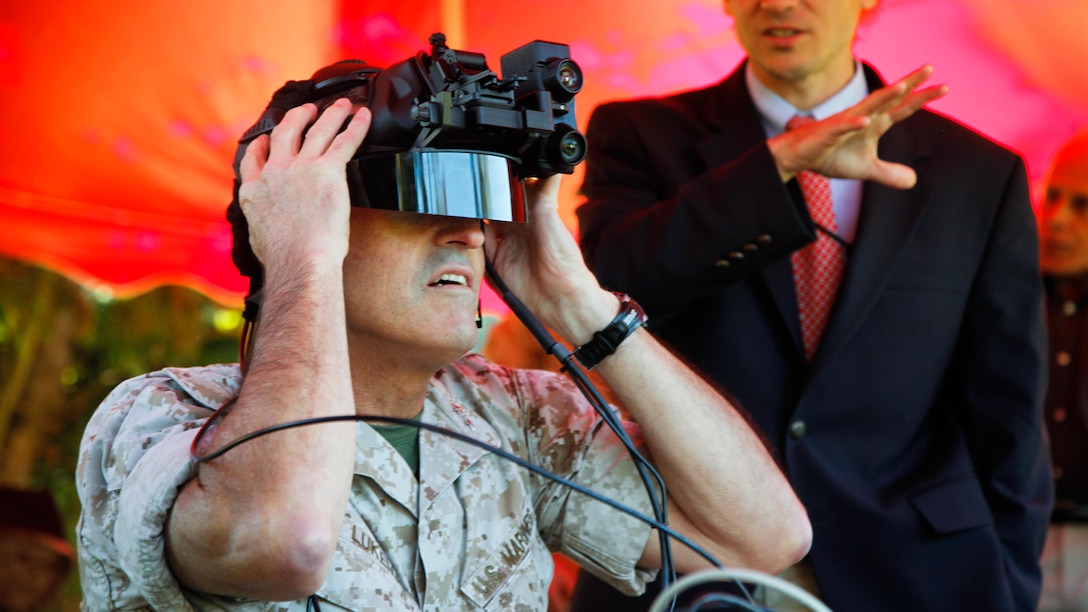 Maj. Gen. James Lukeman, commanding general, Training and Education Command, experiences the Augmented Immersive Team Training system during a demonstration for Marine leadership and key civilian leaders at the Medal of Honor Golf Course, Marine Corps Base Quantico, Virginia, Oct. 14, 2015. The system provides a virtual battlefield complete with aircraft and artillery to engage ground vehicles and personnel with no needs for concerns such as safety, resources or availability of ranges for realistic training.