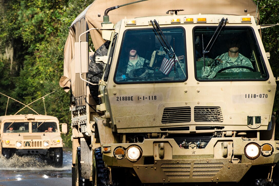 South Carolina Army National Guardsmen drive through floodwaters on their way to deliver sandbags to local residents in Parkers Ferry, S.C., Oct. 9, 2015, in the aftermath of historic flooding in the state. The soldiers are assigned to Company A, 1st Battalion, 118th Infantry Regiment. U.S. Air Force photo by Staff Sgt. Perry Aston