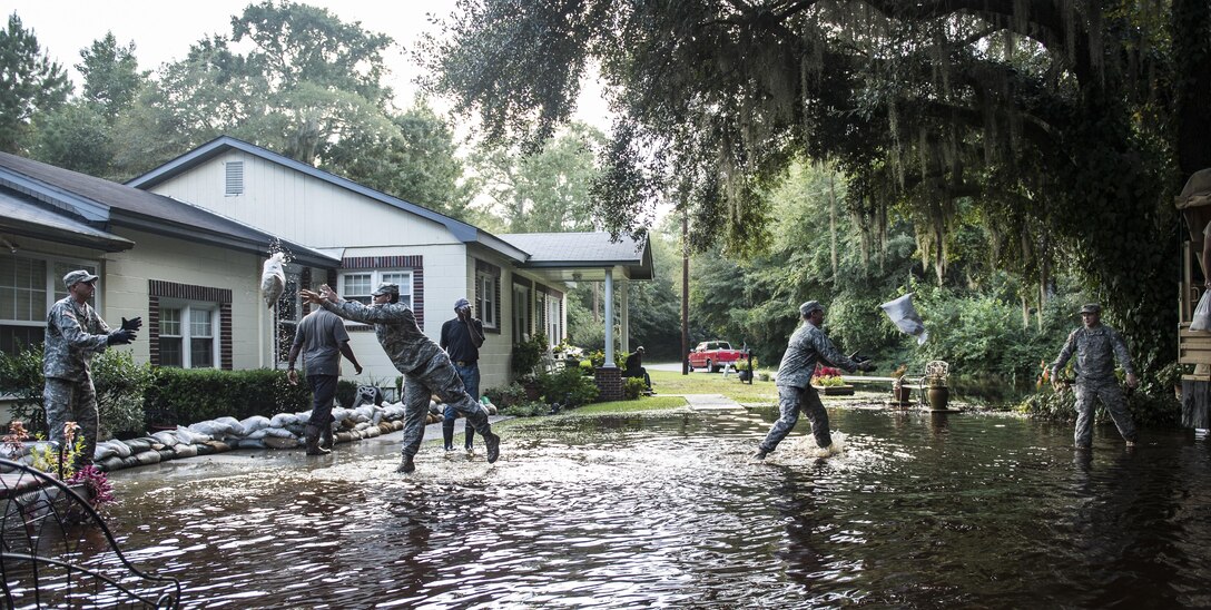 South Carolina Army National Guardsmen unload sandbags to help a resident protect his property in Parkers Ferry, S.C., Oct. 9, 2015, in the aftermath of historic flooding in the state. U.S. Air Force photo by Staff Sgt. Perry Aston