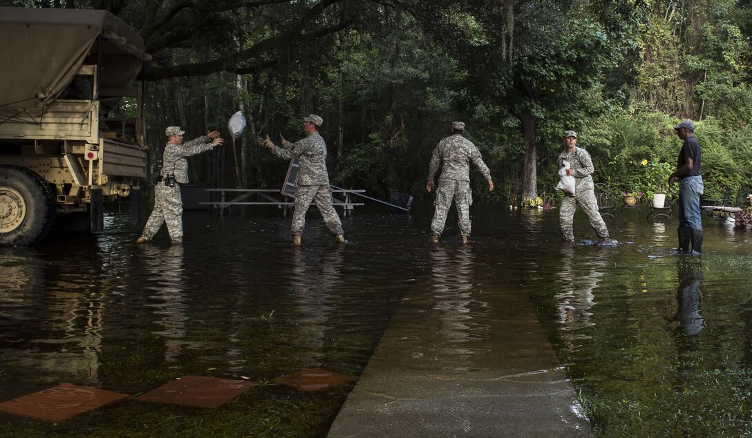 South Carolina Army National Guardsmen unload sandbags to help a resident protect his property in Parkers Ferry, S.C., Oct. 9, 2015, in the aftermath of historic flooding in the state. U.S. Air Force photo by Staff Sgt. Perry Aston 