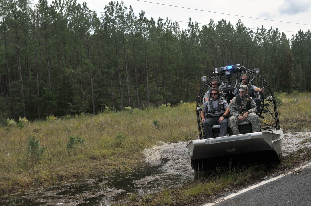 A South Carolina Army National Guardsman works closely with Charleston County Sheriff's airboat crews during flood response operations near Adams Run, S.C., Oct. 9, 2015. The guardsman is assigned to the South Carolina Army National Guard's Company C, 1st Battalion, 118th Infantry Regiment. South Carolina Army National Guard photo by Sgt. Joshua S. Edwards