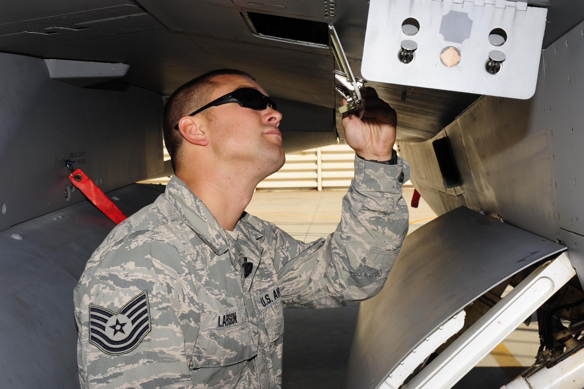 U.S. Air Force Tech. Sgt. Brett Larson, 134th Expeditionary Fighter Squadron F-16 Fighting Falcon crew chief, Vermont Air National Guard, inspects a hydraulic reservoir gage at Kunsan Air Base, Republic of Korea, Oct. 6, 2015. The 134th EFS was redeployed from Kadena Air Base, Japan to Kunsan AB as part of a theater security package. Larson deployed to Kunsan with more than 200 other guardsmen as part of a theater security package to increase large force U.S. military combat capabilities. (U.S. Air Force photo by Staff Sgt. Nick Wilson/Released)