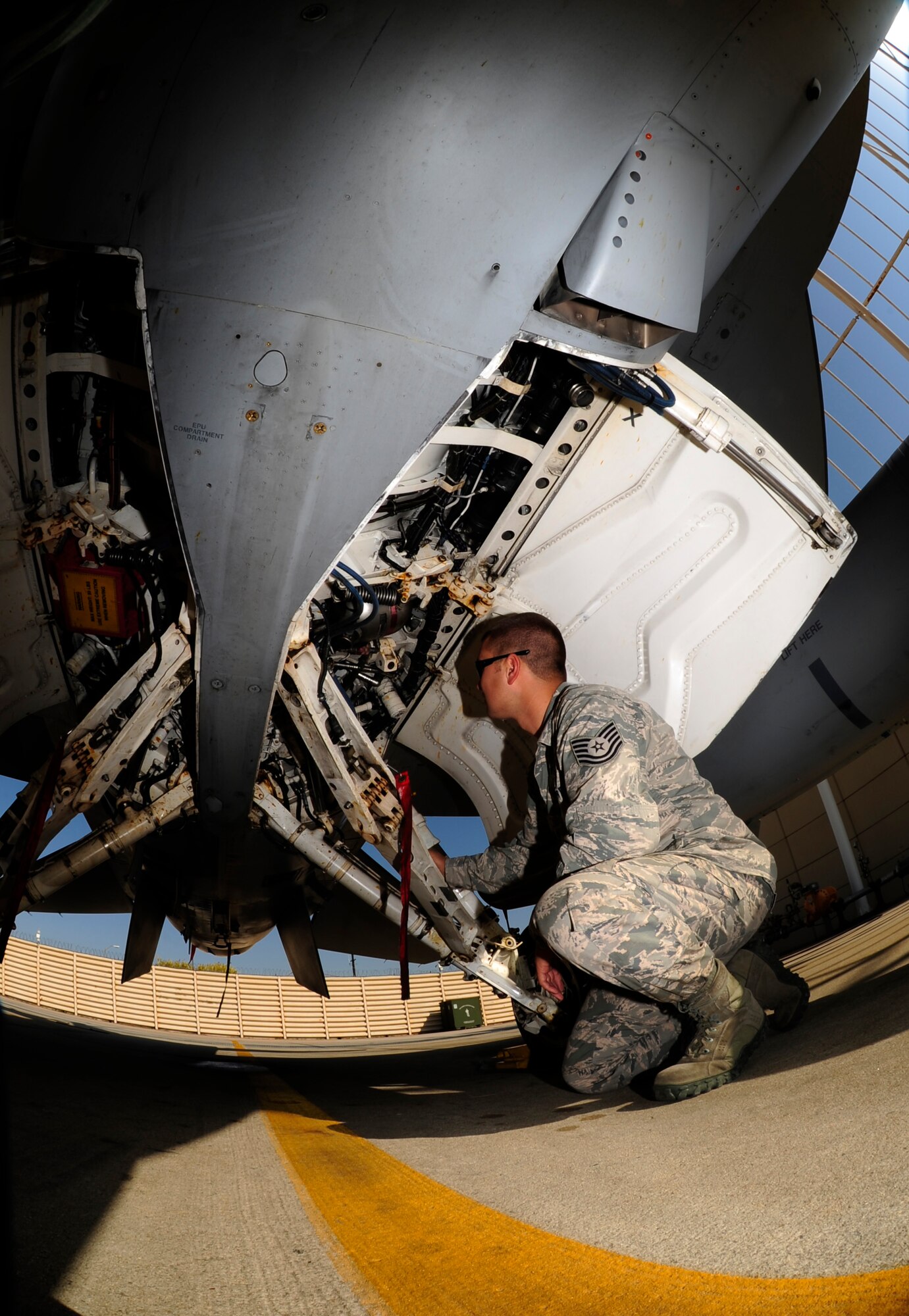 U.S. Air Force Tech. Sgt. Brett Larson, 134th Expeditionary Fighter Squadron F-16 Fighting Falcon crew chief, Vermont Air National Guard, inspects the landing gear of an F-16 at Kunsan Air Base, Republic of Korea, Oct. 6, 2015. The 134th EFS was redeployed from Kadena Air Base, Japan to Kunsan AB as part of a theater security package. TSP deployments provide the Asia-Pacific Region with forces capable of a variety of operations, including access to the global commons, disaster relief, global situational awareness, combating piracy, active defense and power projection. (U.S. Air Force photo by Staff Sgt. Nick Wilson/Released) 