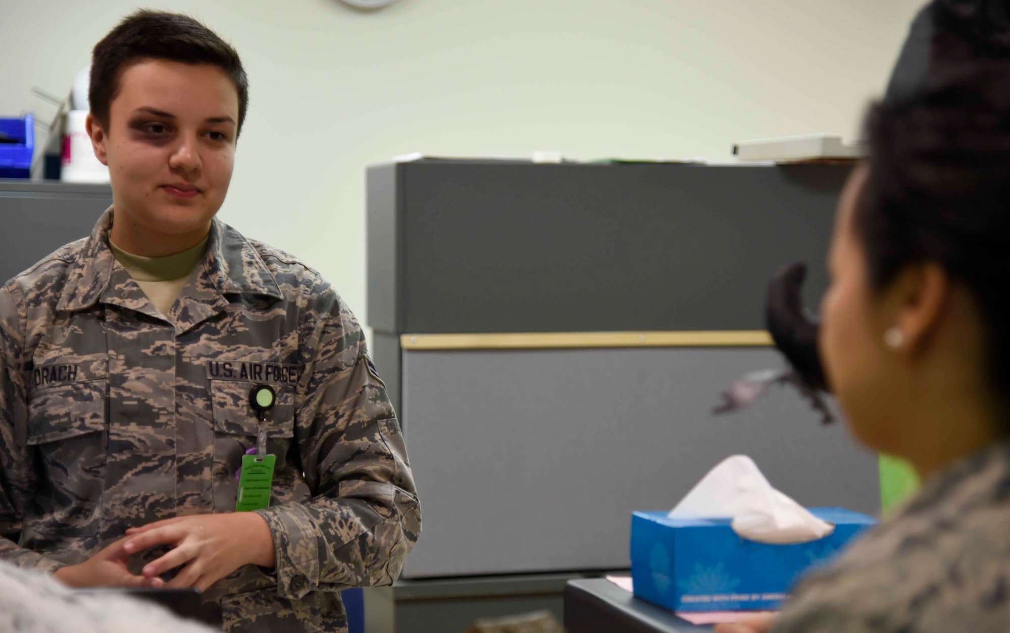 U.S. Air Force Airman 1st Class Monica Drach, 35th Medical Operations Squadron family practice administration technician, speaks to Master Sgt. Judy Khamphan, 35th Medical Support Squadron flight chief, at Misawa Air Base, Japan, Oct. 15, 2015. Khamphan showed concern for Drach upon noticing her black eye, which was makeup applied for the "In Your Face Black Eye Campaign." Reactions like this were recorded and reviewed by family health to determine where to focus their outreach programs. (U.S. Air Force photo by Airman 1st Class Jordyn Fetter/Released) 