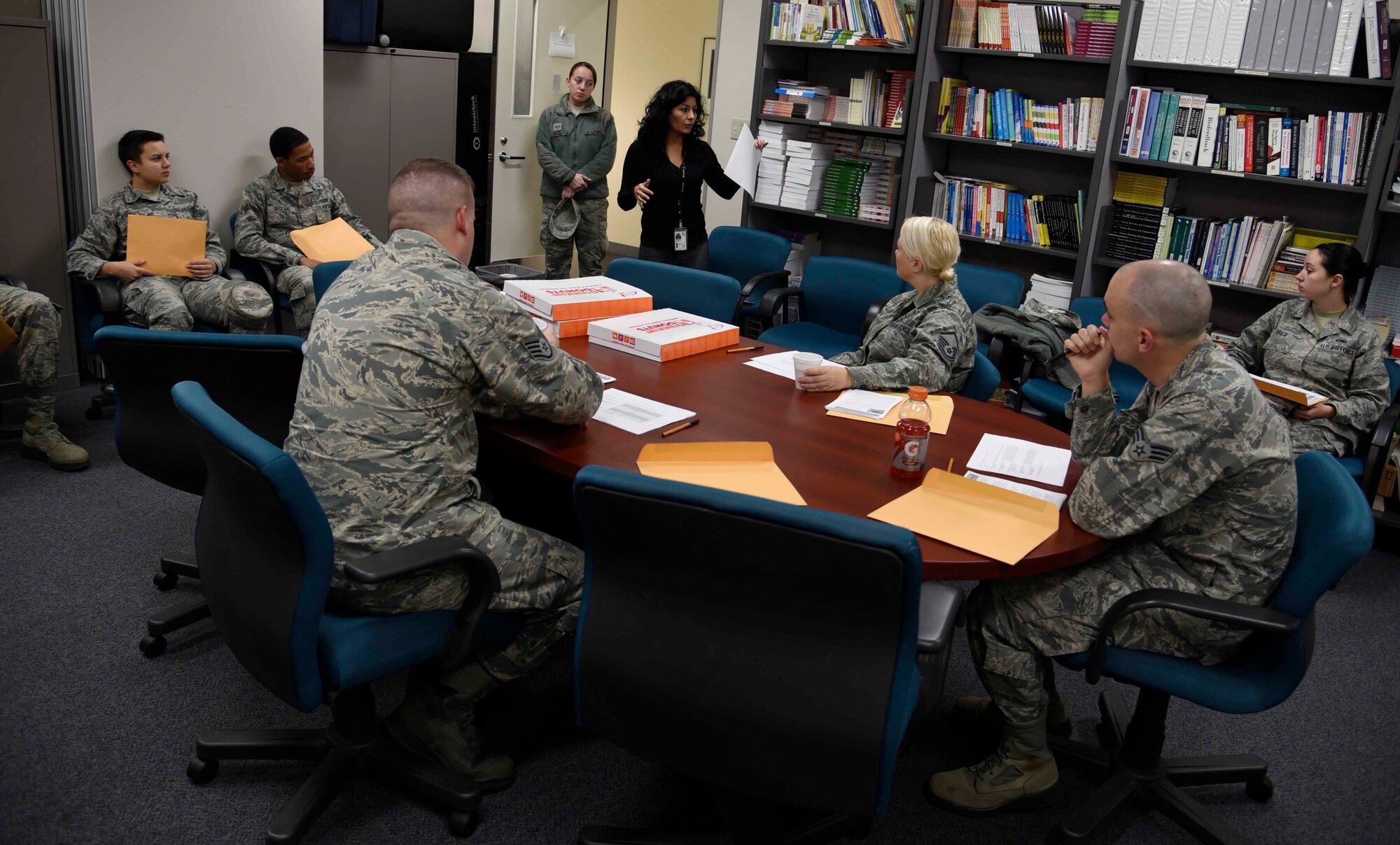 Rosanne Pizano, 35th Medical Operations Squadron domestic abuse victim advocate, speaks to volunteers at Misawa Air Base, Japan, Oct. 15, 2015. The topic of discussion is the "In Your Face Black Eye Campaign," an exercise conducted in support of Domestic Violence Awareness Month. Eleven Airmen and one civilian from different base squadrons volunteered to don black eye makeup during their normal duty day as part of the exercise. (U.S. Air Force photo by Airman 1st Class Jordyn Fetter/Released) 