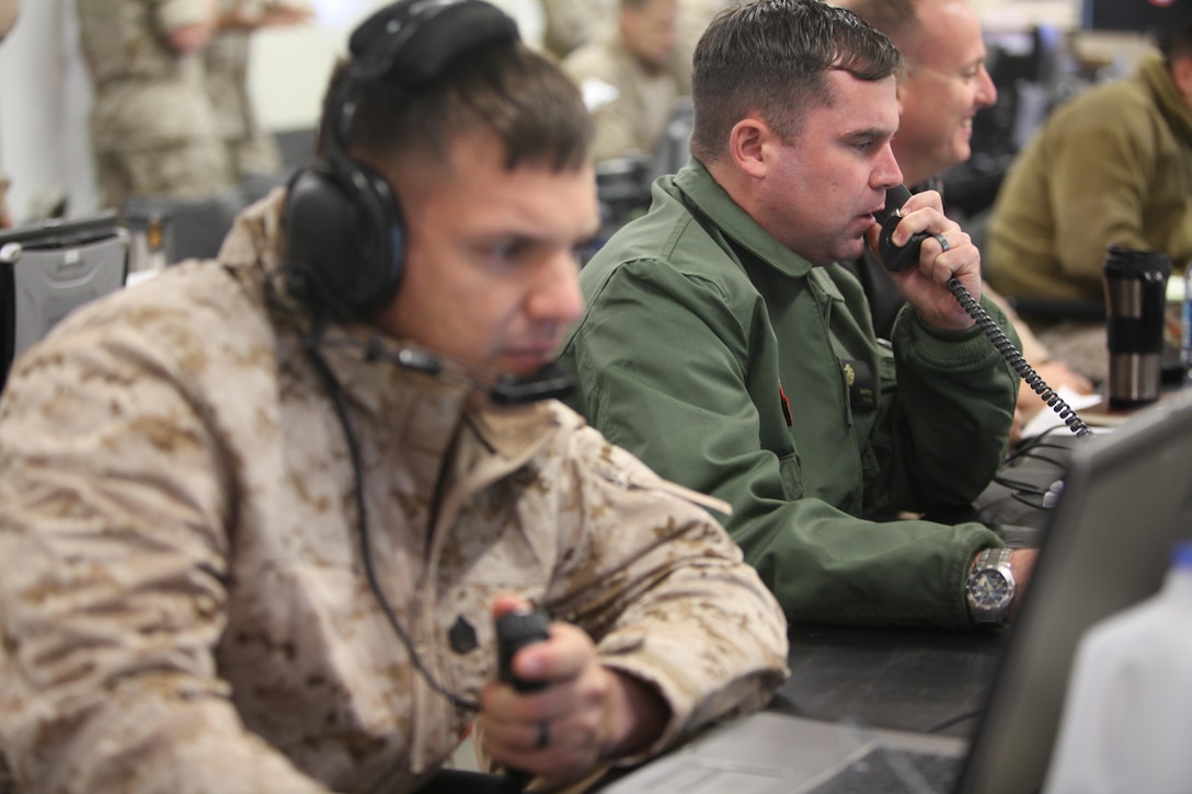 2nd Marine Aircraft Wing Marines initiate and assist with flight requests during Wing Exercise 15 at Marine Corps Air Station Cherry Point, North Carolina, Oct.13, 2015. Performing defensive and offensive measures to counter both traditional and irregular threats based on today’s real world adversaries, the Marines and Sailors learned to work together to accomplish various missions by conducting Tactical Air Command Center operations during Wing Exercise 15, at Marine Corps Air Station Cherry Point, North Carolina, Oct. 13-16.