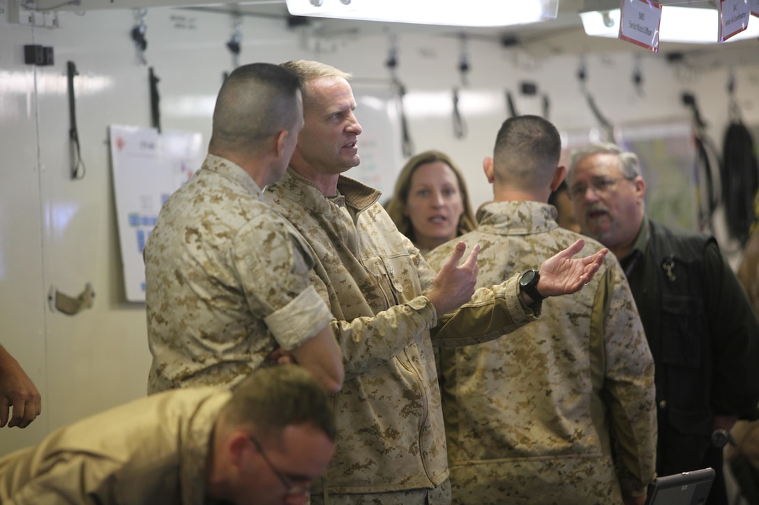 Lt. Col. Bradley Philips updates Col. Mark Palmer, the 2nd Marine Aircraft Wing chief of staff, on the status of current operations for the aviation combat element during Wing Exercise 15, at Marine Corps Air Station Cherry Point, North Carolina, Oct. 13, 2015. During the exercise, the Marines participated in various scenarios that tested their ability to use defensive and offensive strategies in order to maximize readiness and efficiency of 2nd MAW. Phillips served as the senior watch officer during the exercise.