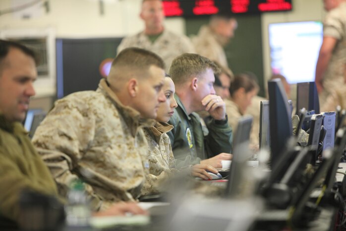 2nd Marine Aircraft Wing Marines assess scenarios with fixed-wing assets during Wing Exercise 15, at Marine Corps Air Station Cherry Point, North Carolina, Oct. 13, 2015. Performing defensive and offensive measures to counter both traditional and irregular threats based on today’s real world adversaries, the Marines and Sailors learned to work together to accomplish various missions by conducting Tactical Air Command Center operations during Wing Exercise 15, at Marine Corps Air Station Cherry Point, North Carolina, Oct. 13-16.