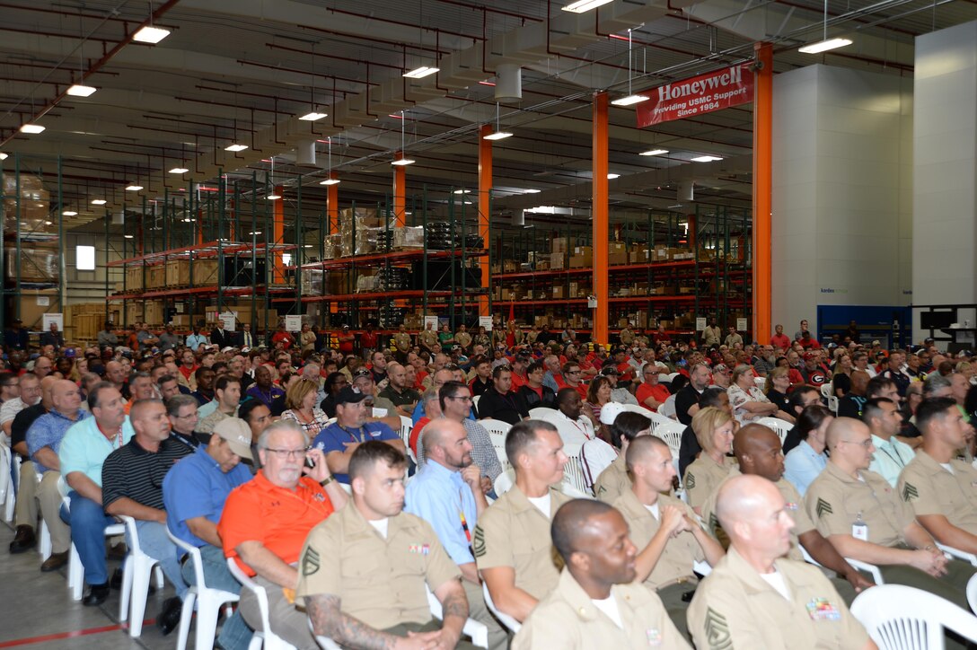 Marines, civilian-Marines and contractor employees with Blount Island Command and Marine Corps Support Facility Blount Island in Jacksonville, Fla., listen to distinguished visitors during a Voluntary Protection Program Star sites ceremony, Oct. 16.