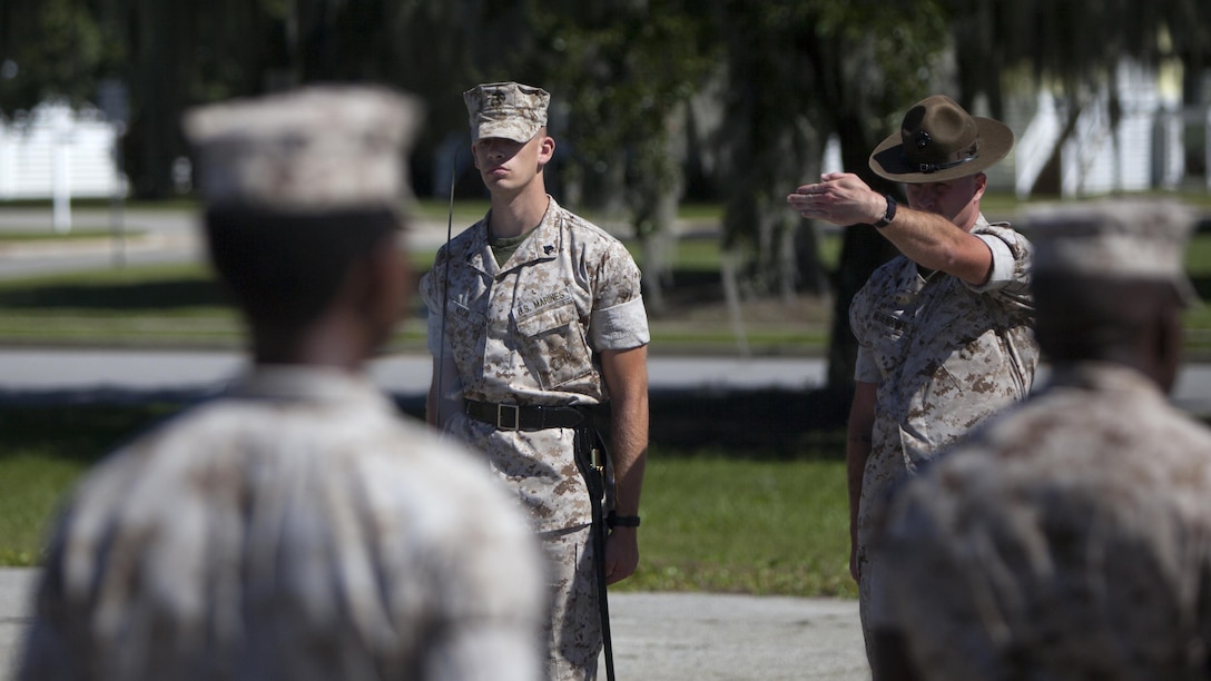 A Marine student attending dril instructor school listens to correction from his instructor while practicing drill at Marine Corps Recruit Depot Parris Island, S.C., Oct. 15, 2015. Marines who attend drill instructor school are specially selected and the school is three months long. 