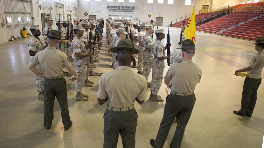 Regimental drillmasters, experts on the Marine Corps drill and ceremonies manual, critique recruits of Golf Company, 2nd Recruit Training Battalion, during an initial drill evaluation Sept. 29, 2014, at Marine Corps Recruit Depot Parris Island, S.C. The recruits practiced daily for four weeks in anticipation of the evaluation. 
